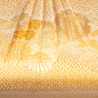 Close up of vintage Japanese silk clutch bag in metallic gold with floral, basketweave and genji wheel patterns.