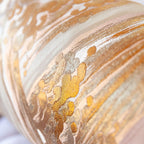 Detail of flowing araumi wave design across pink vintage silk with layered gold tones