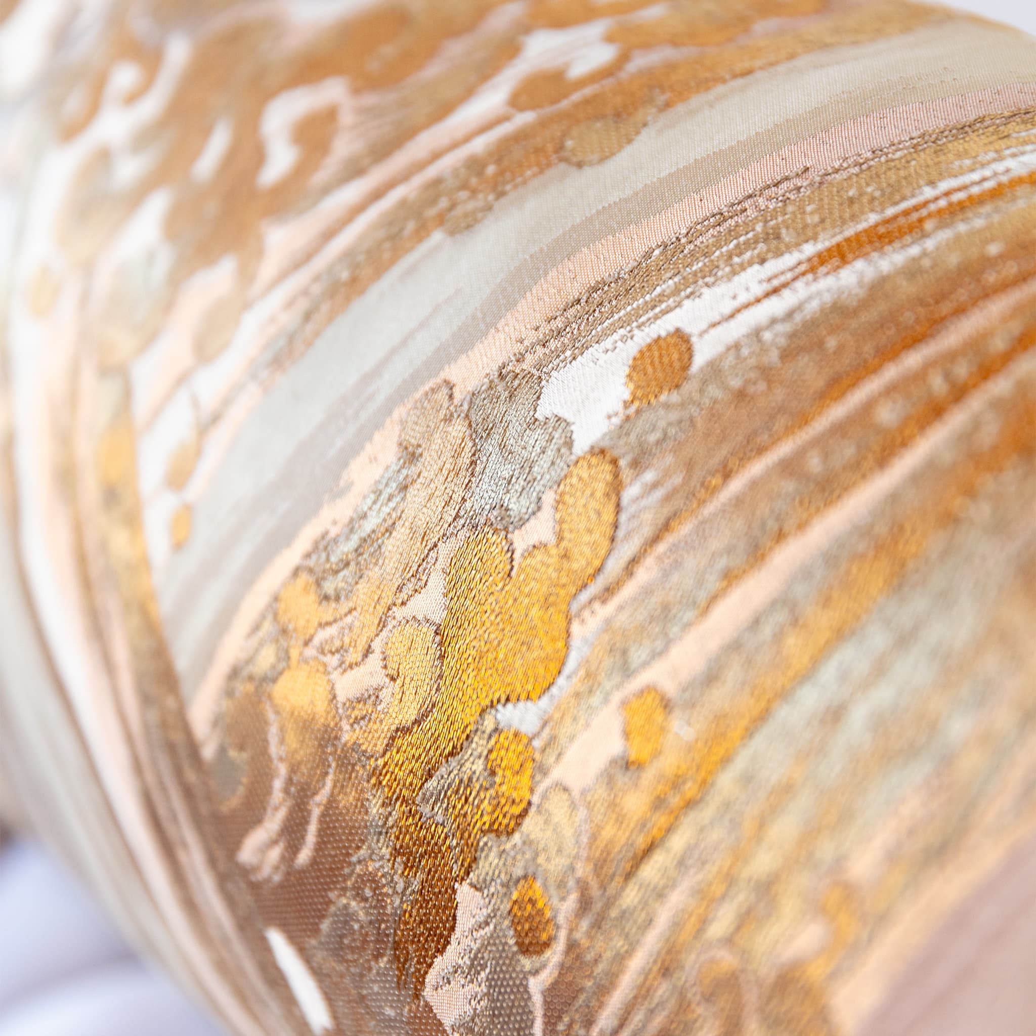 Detail of flowing araumi wave design across pink vintage silk with layered gold tones