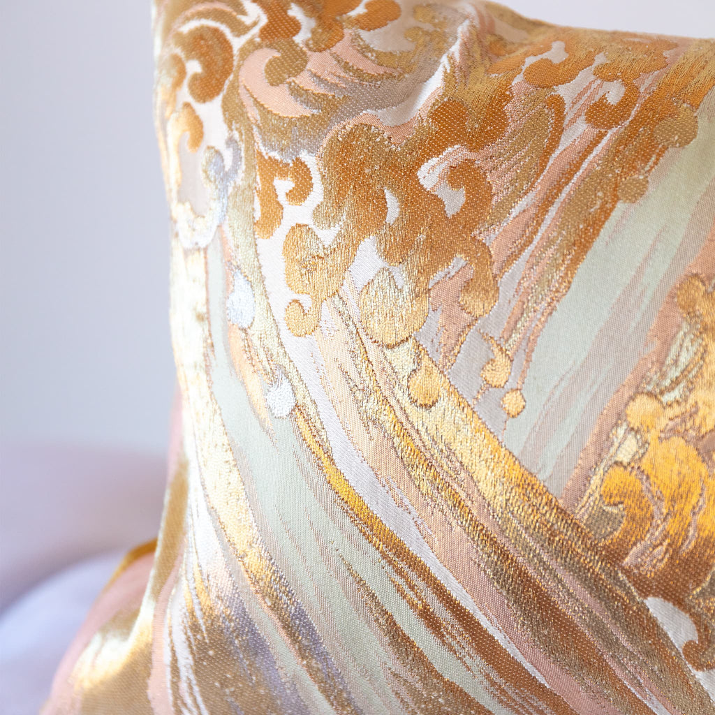 Close up of vintage Japanese obi bolster pillow end showing gilt thread woven wild waves pattern.