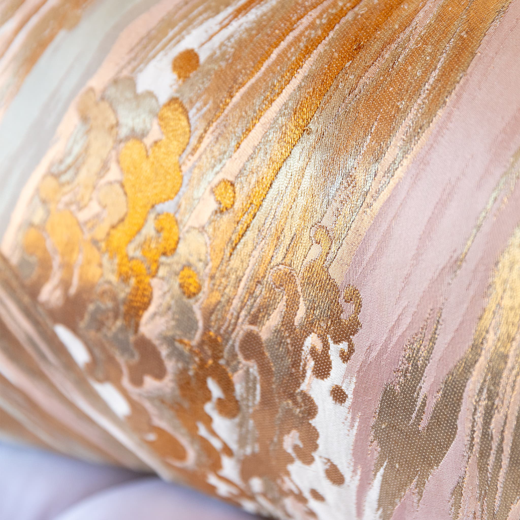 Close-up of bolster cushion curve showing silk sheen and araumi wave pattern