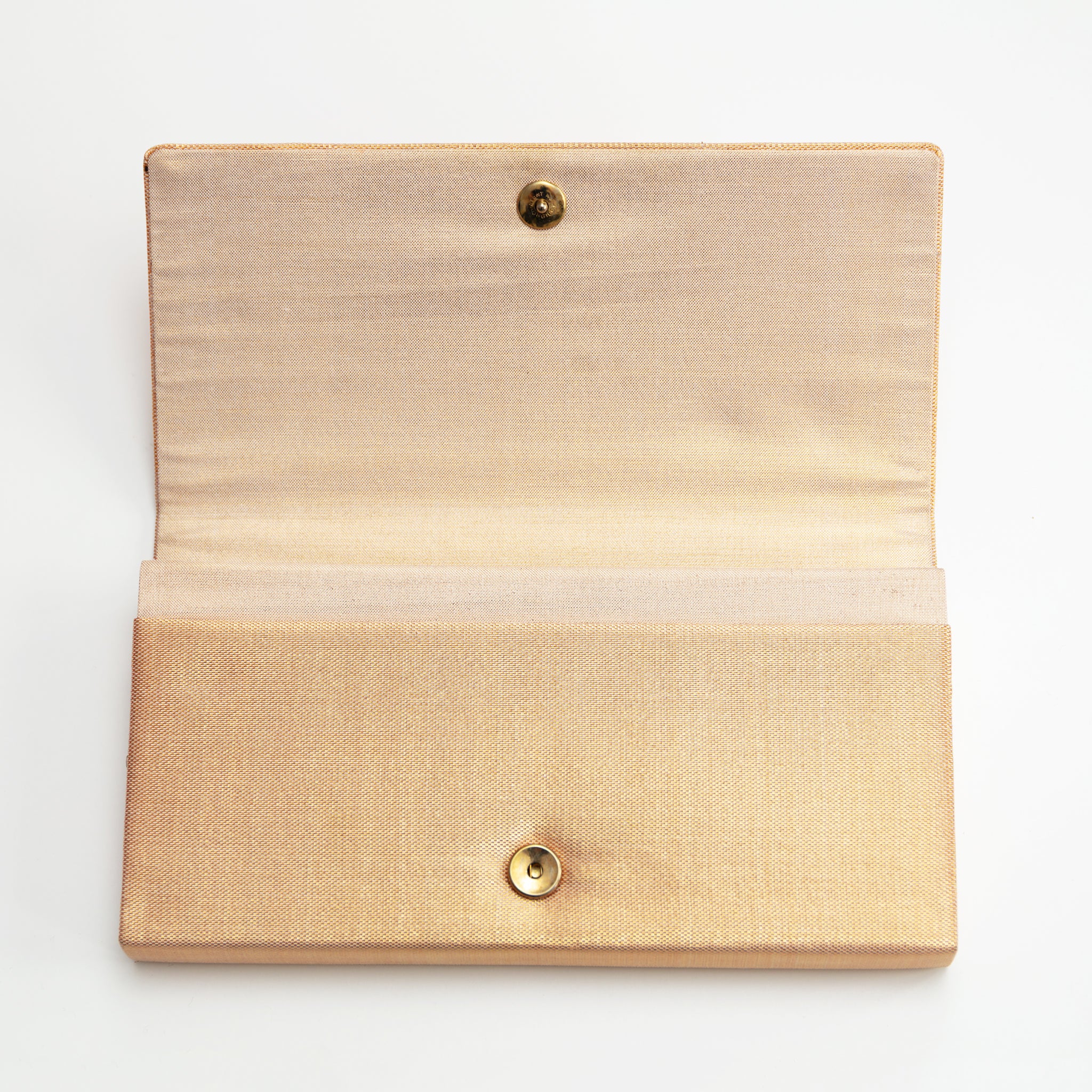 Gold vintage silk envelope clutch bag with the flap open to show the silk lining inside and the metal fastener. 