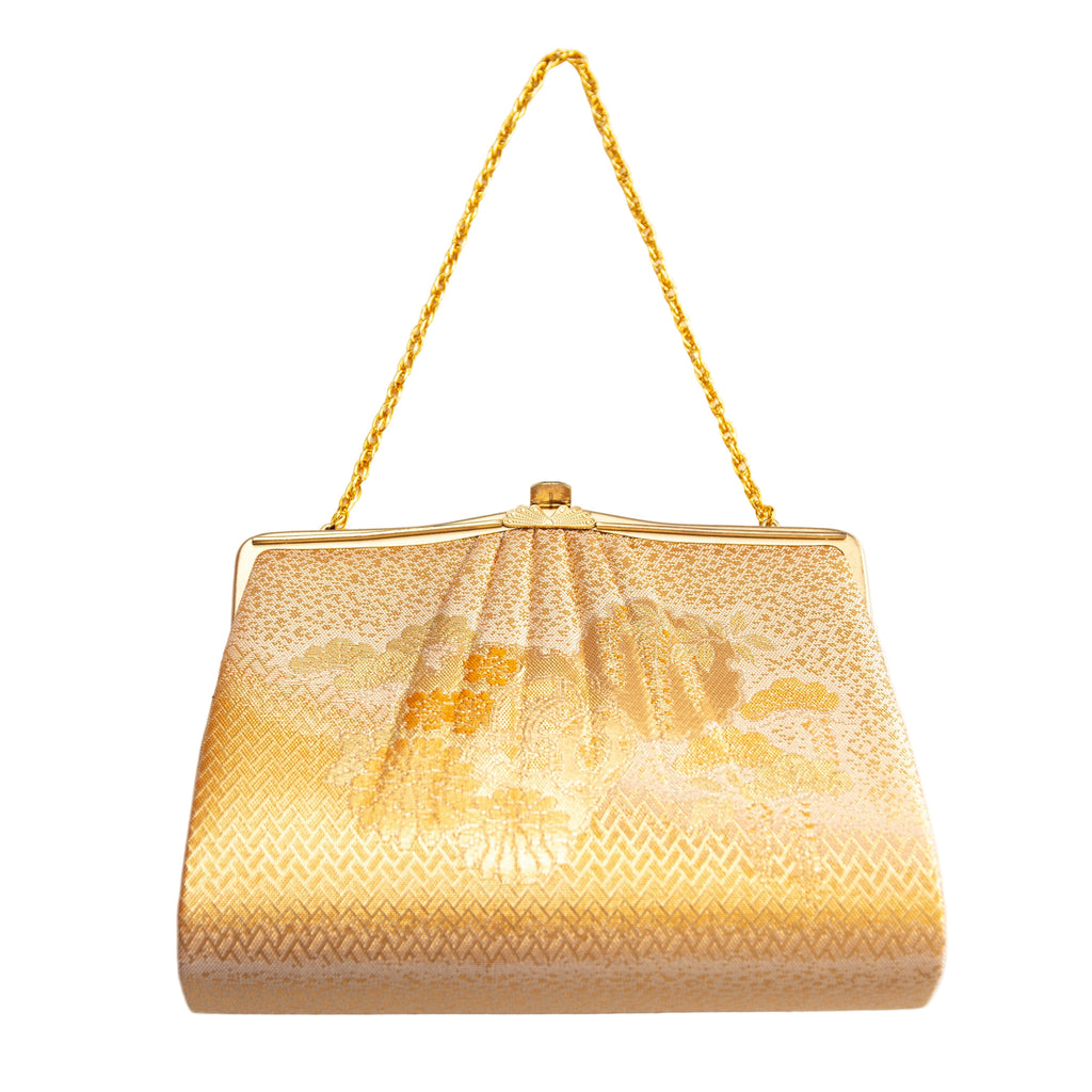 Vintage Japanese silk clutch bag in gold with floral pattern and gold chain strap on white background.
