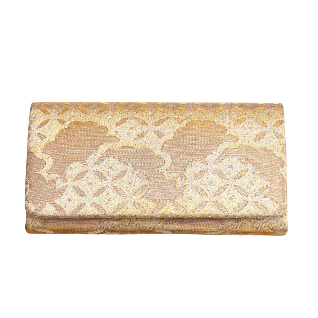 Vintage Japanese kimono silk clutch bag in gold silk brocade with clouds and shippo pattern design on a white background.