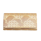 Vintage Japanese kimono silk clutch bag in gold silk brocade with clouds and shippo pattern design on a white background.