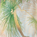 Detail of green pine motif on pale blue and beige vintage Japanese obi silk