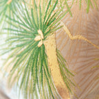 Close-up of woven green pine needles and gold detailing on vintage fukuro obi silk
