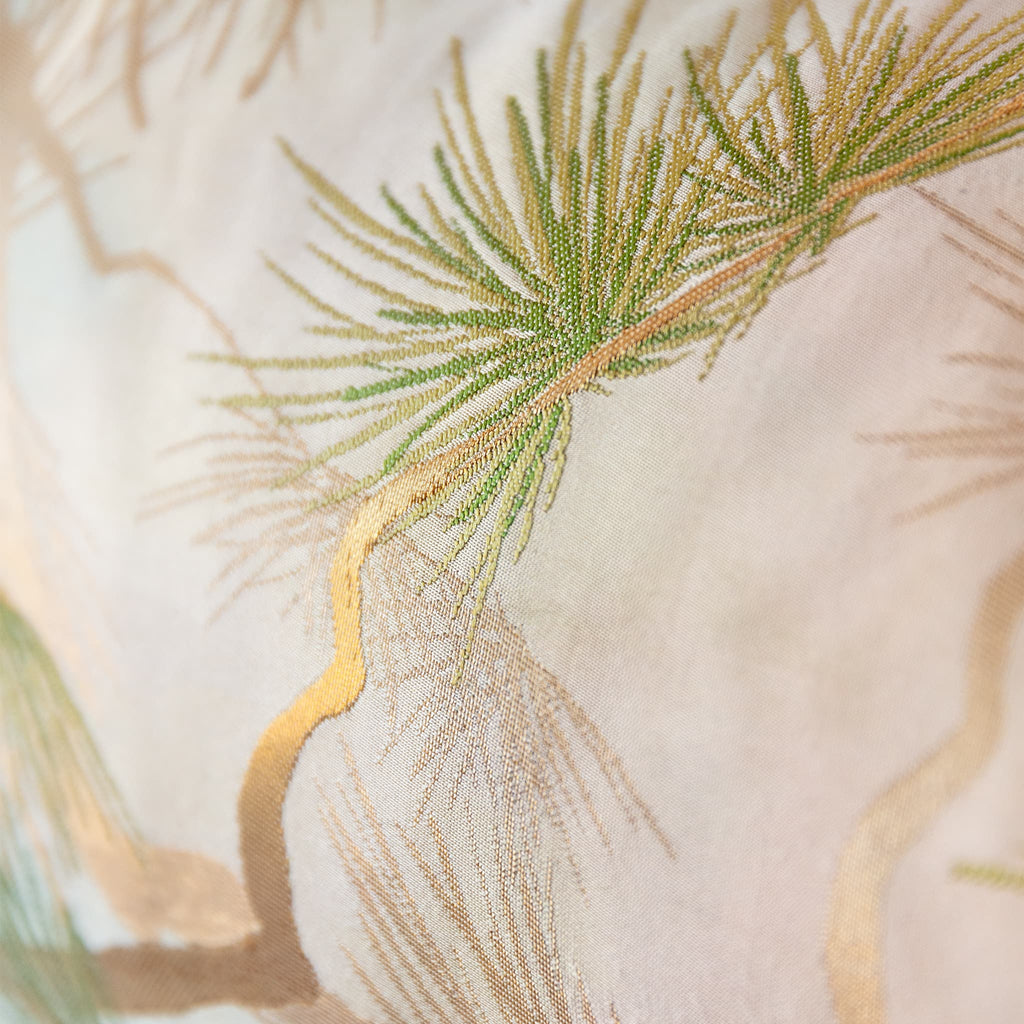 Detail of metallic gold pine trunk and green needles on vintage Japanese obi silk