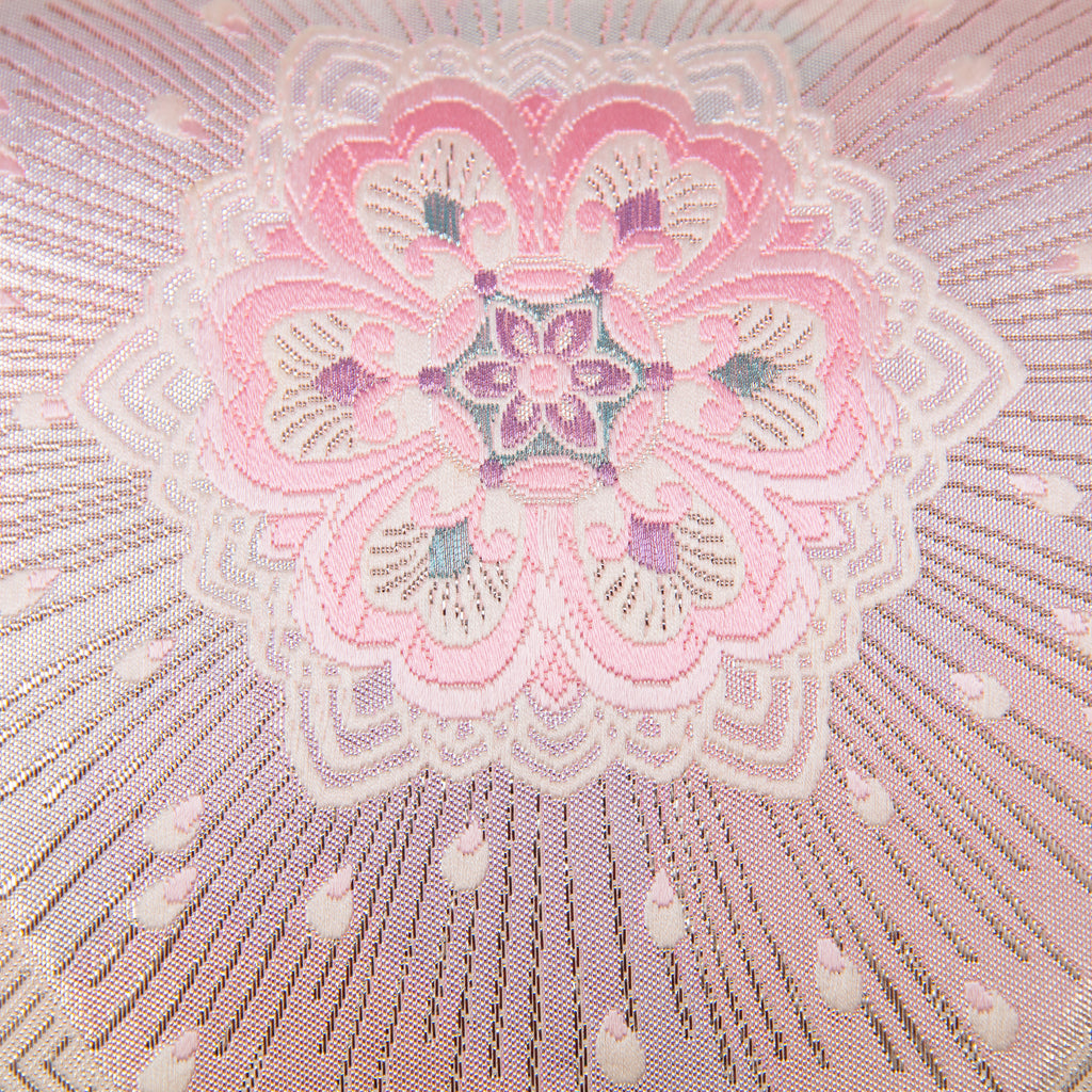 Detail of pink floral design and silver starburst accent on the obi cushion.