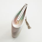 Side view of a multicoloured vintage Japanese silk clutch  bag showing iridescent side panel in silk and the silver bag frame.