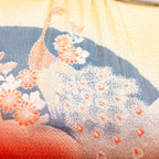 Close up detail of the vintage Japanese bag design showing woven peacock in gold over a black fan and geometric pattern design.
