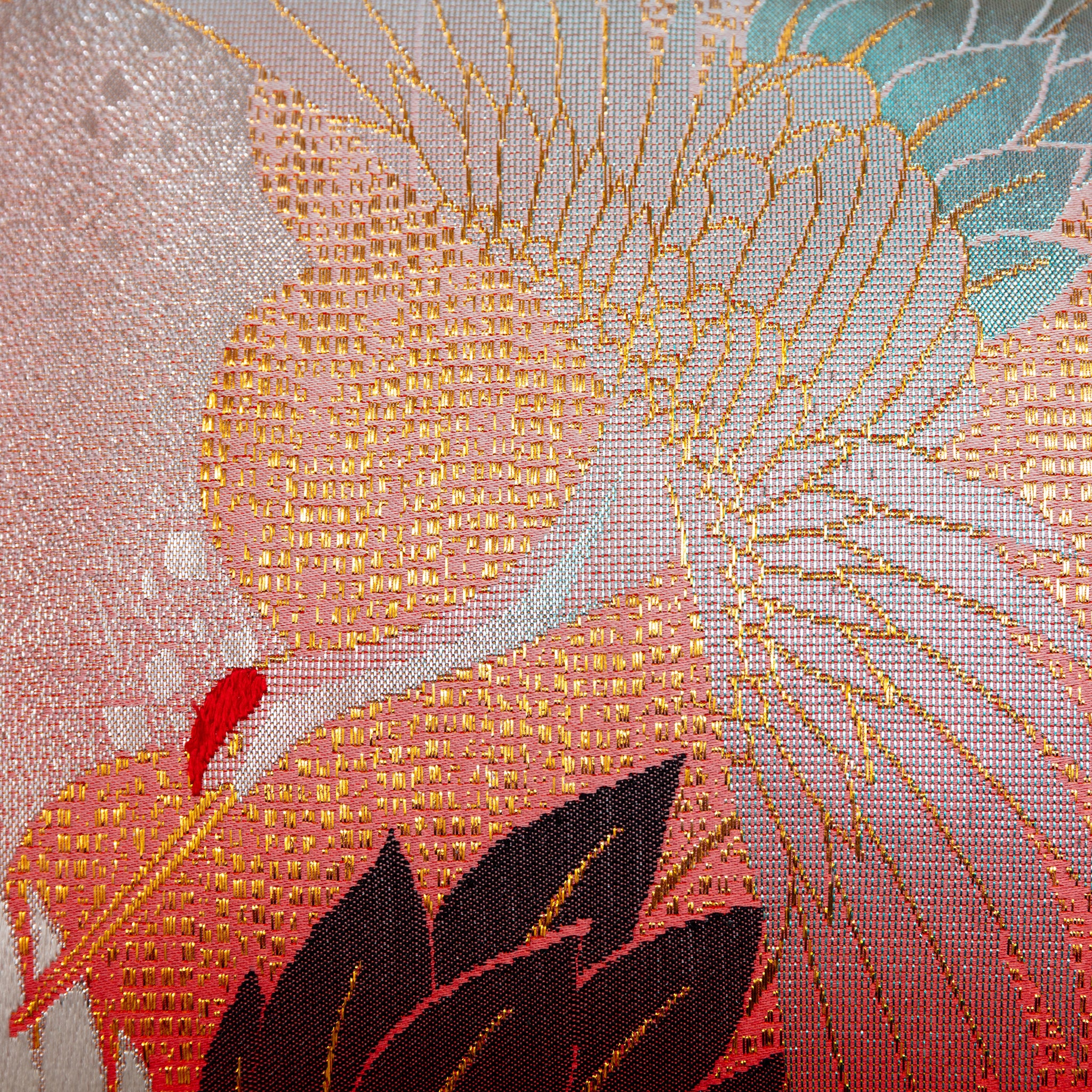 Close-up of the red silk and taupe velvet fabric combined with detailed stitching on the bolster pillow's corner.