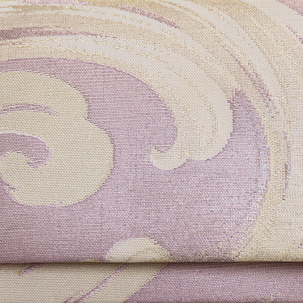 Close up detail of lilac woven silk vintage clutch bag surface showing cream and silver woven silk waves pattern over lilac pale pink base.
