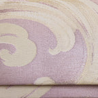 Close up detail of lilac woven silk vintage clutch bag surface showing cream and silver woven silk waves pattern over lilac pale pink base.