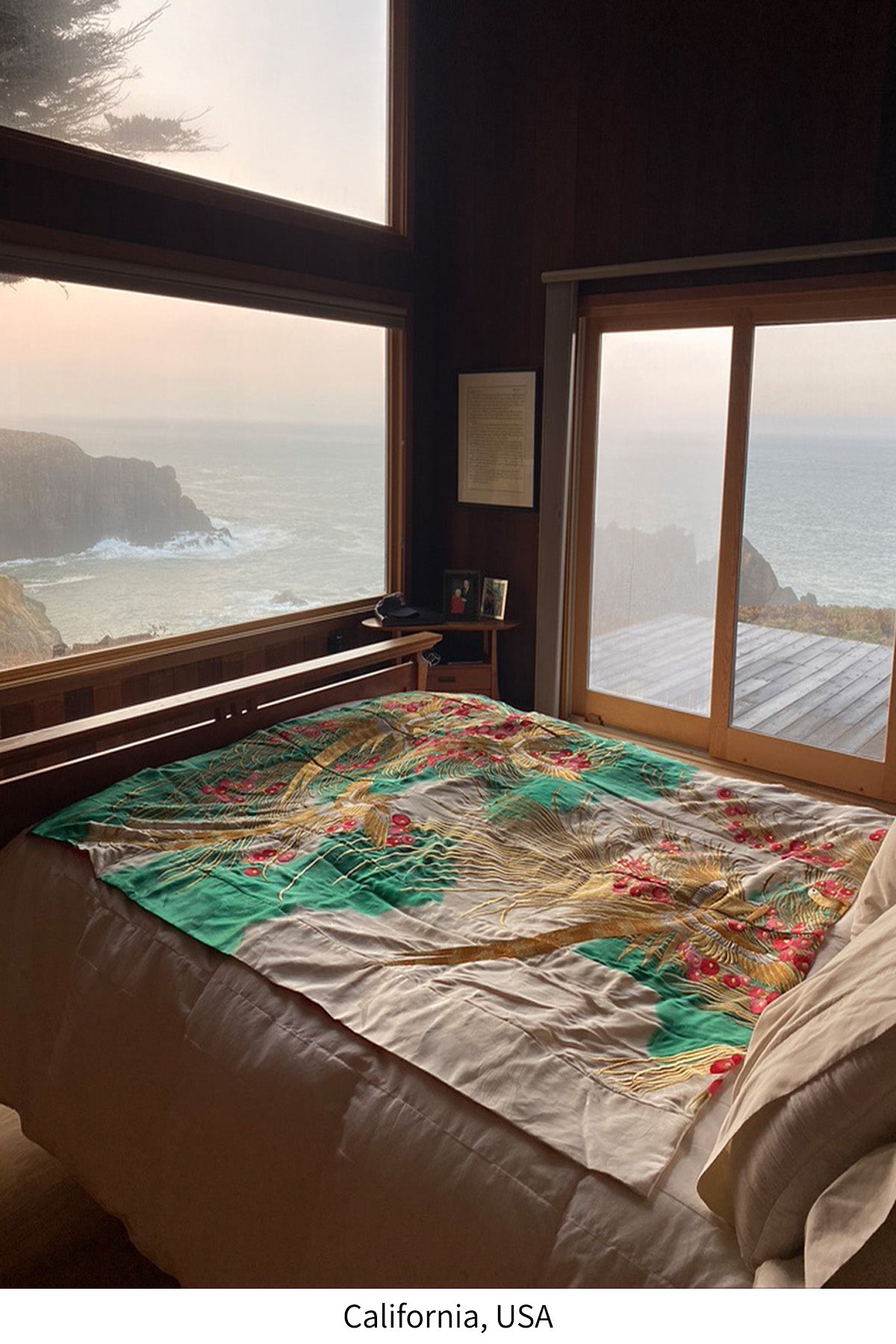 Customer photo of a vintage Japanese silk throw from Kimono Living in an ocean-view bedroom in California, USA.