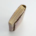 Side view of vintage Japanese kimono silk clutch bag showing metallic gold folded side panel.