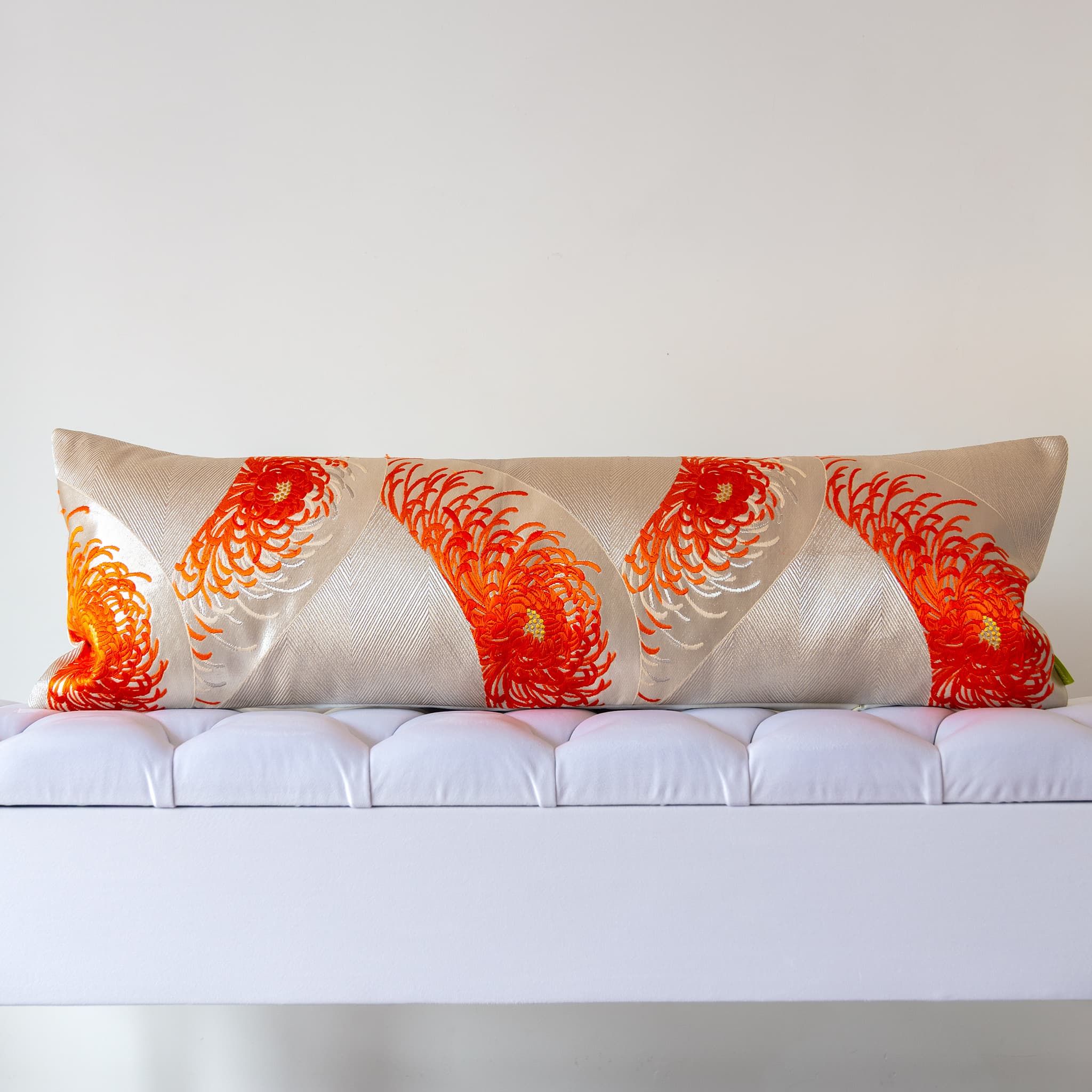 Long silver silk bolster cushion with spider chrysanthemums in flame and burnt orange on vintage Japanese Fukuro Obi silk