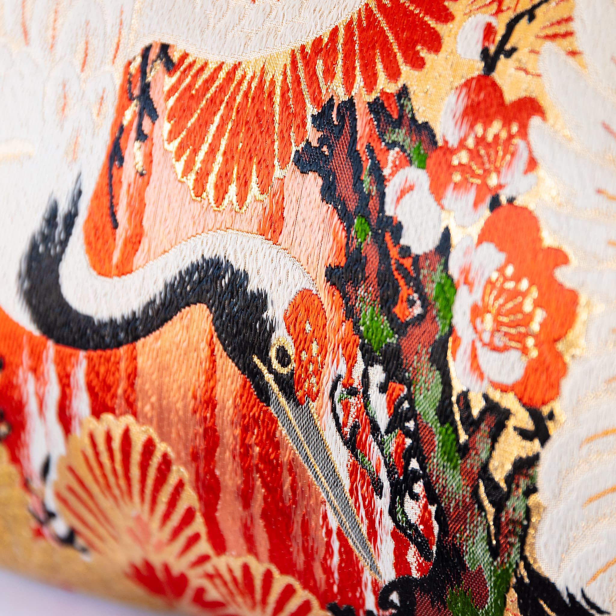 Crane and stylised pine fan motif close-up, golden Japanese Maru Obi silk bolster cushion