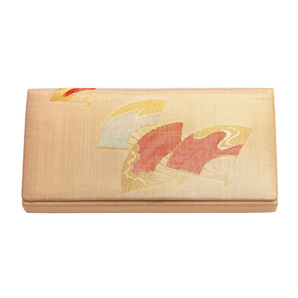 Vintage Japanese silk clutch bag in gold with fans motifs on a white background.