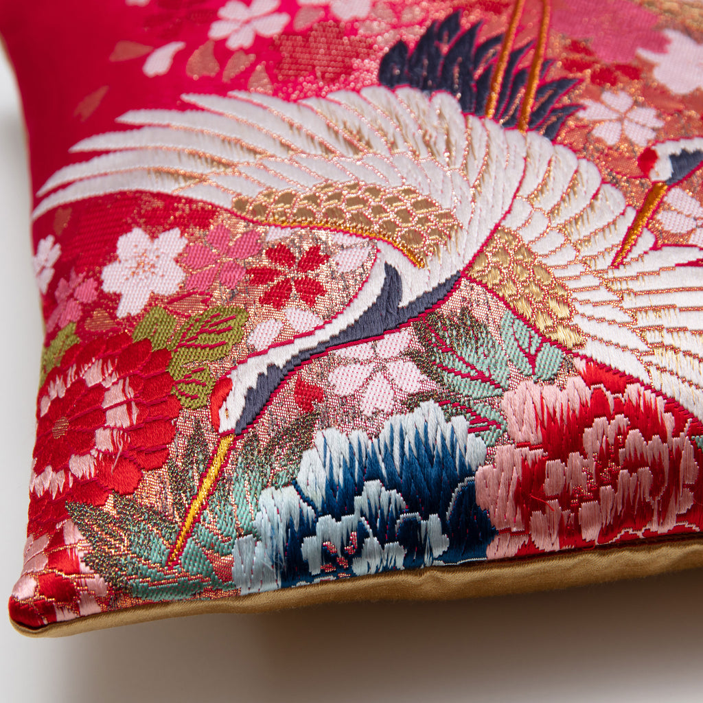 close up of corner of square cushion in vintage kimono silk, crane and floral embroidery, gold satin reverse