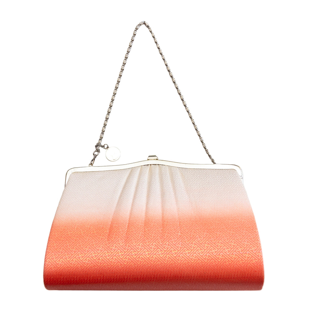 Reverse view of the vintage Japanese silk clutch bag in peach colour ombre with silver metal clasp and chain strap.