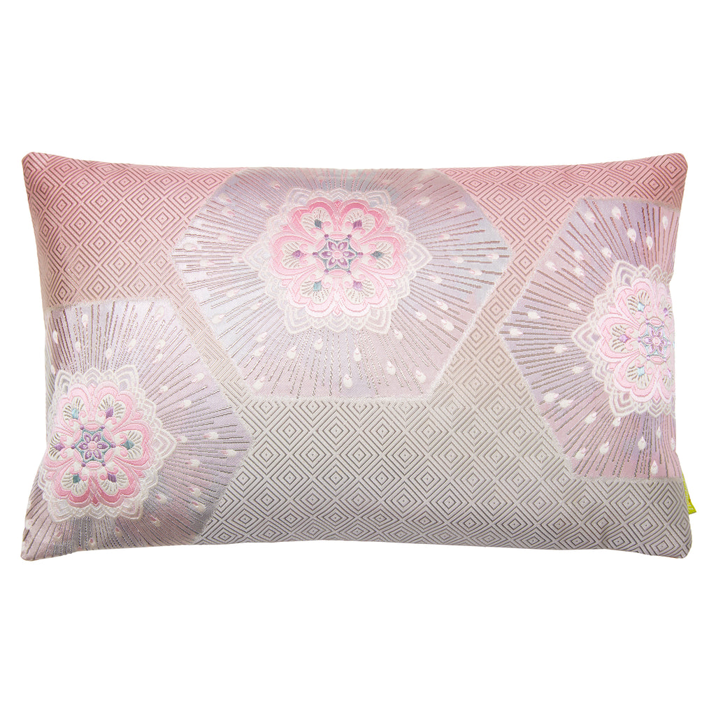 A rectangular pink ombre silk cushion with silver accents and geometric patterns, featuring flowers, hexagons and pinebark diamond designs.