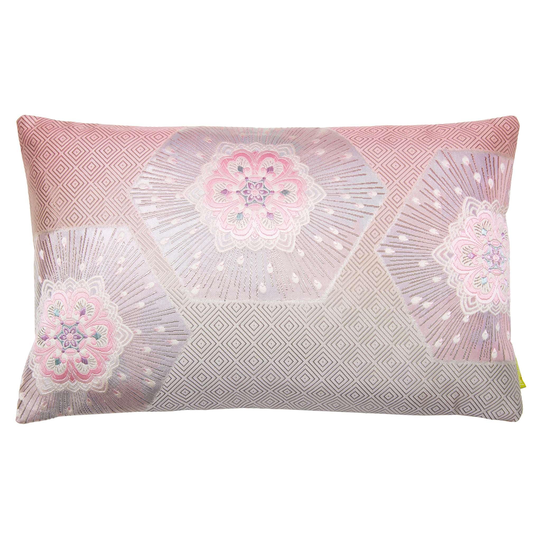 A rectangular pink ombre silk cushion with silver accents and geometric patterns, featuring flowers, hexagons and pinebark diamond designs.