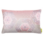 A rectangular silk cushion with a pink ombre background featuring silver hexagons and floral patterns, and a geometric pinebark diamond pattern.