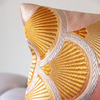Corner detail of pink silk bolster cushion with gold fan motif and silver edging