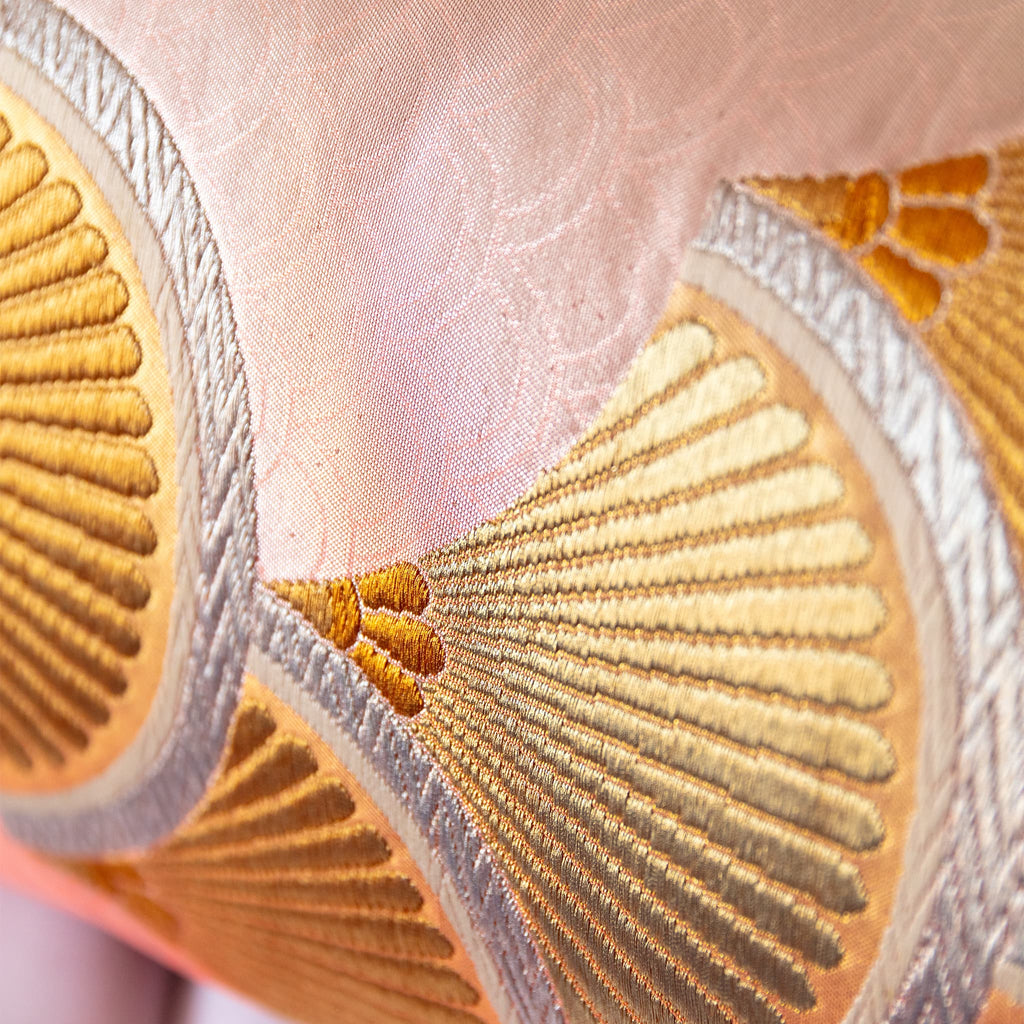 Detail of gold and silver fan motif woven into pink seigaiha pattern vintage Japanese obi silk