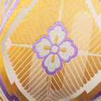 Detail of purple and silver hanabishi obi motif on metallic gold pine bark diamond pattern base.