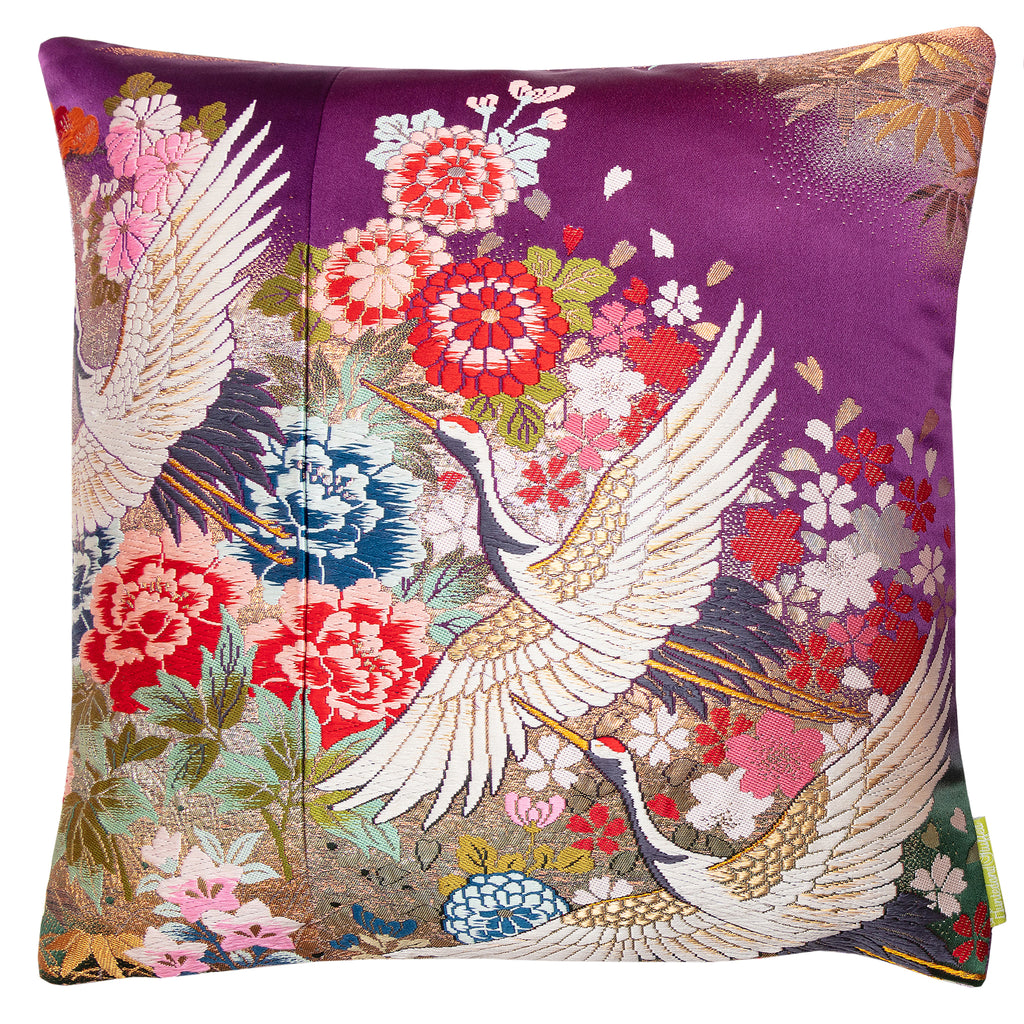 square silk cushion made from vintage kimono silk, purple base with multicoloured embroidery of cranes ans flowers, gold accents.