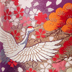 Close-up of the embroidered purple velvet band and pink ombre fabric detail at the bolster’s top edge, highlighting
