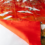 red vintage kimono silk throw with corner turned up to show the red silk lining on the other side