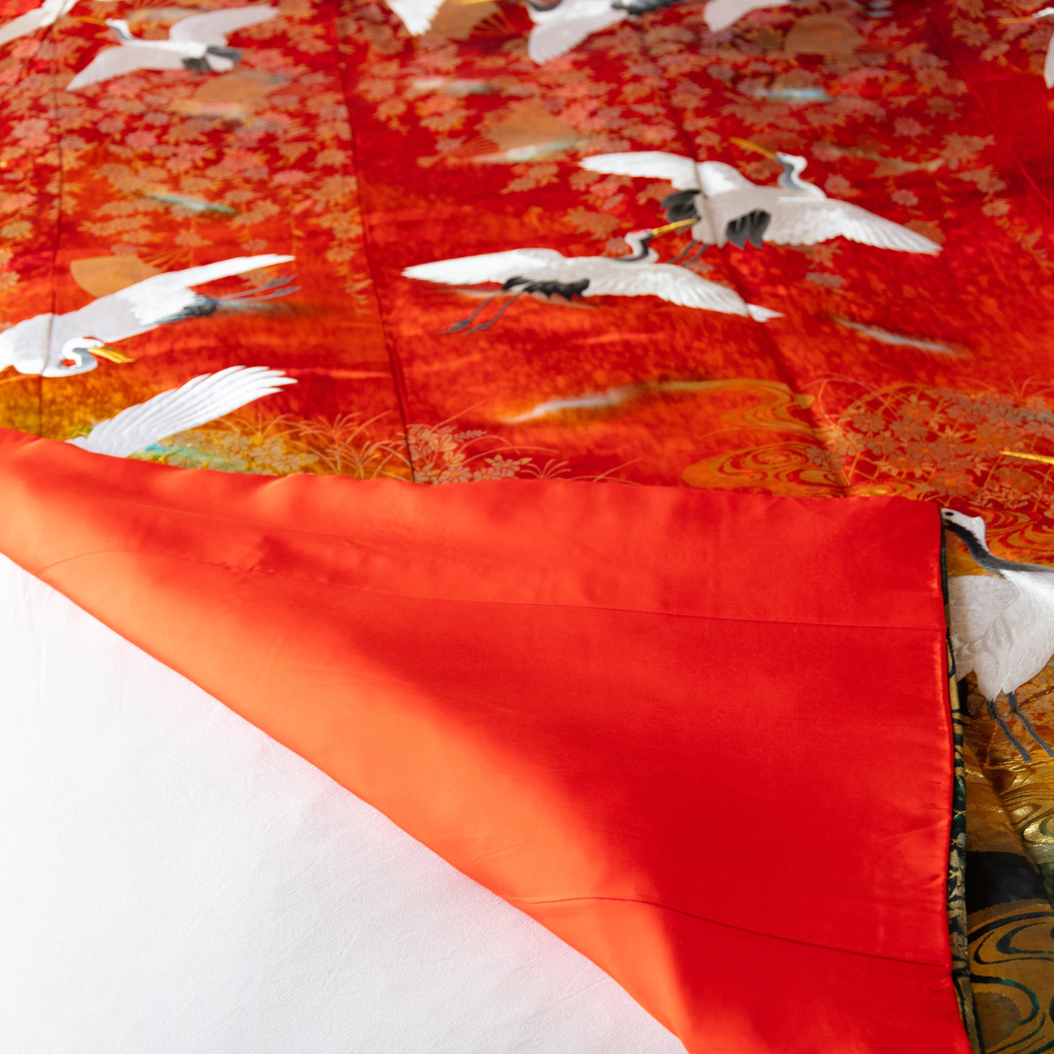 red vintage kimono silk throw with corner turned up to show the red silk lining on the other side