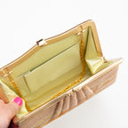 Interior of vintage Japanese silk clutch bag showing cream silk lining, internal pocket and gold chain strap tucked inside.