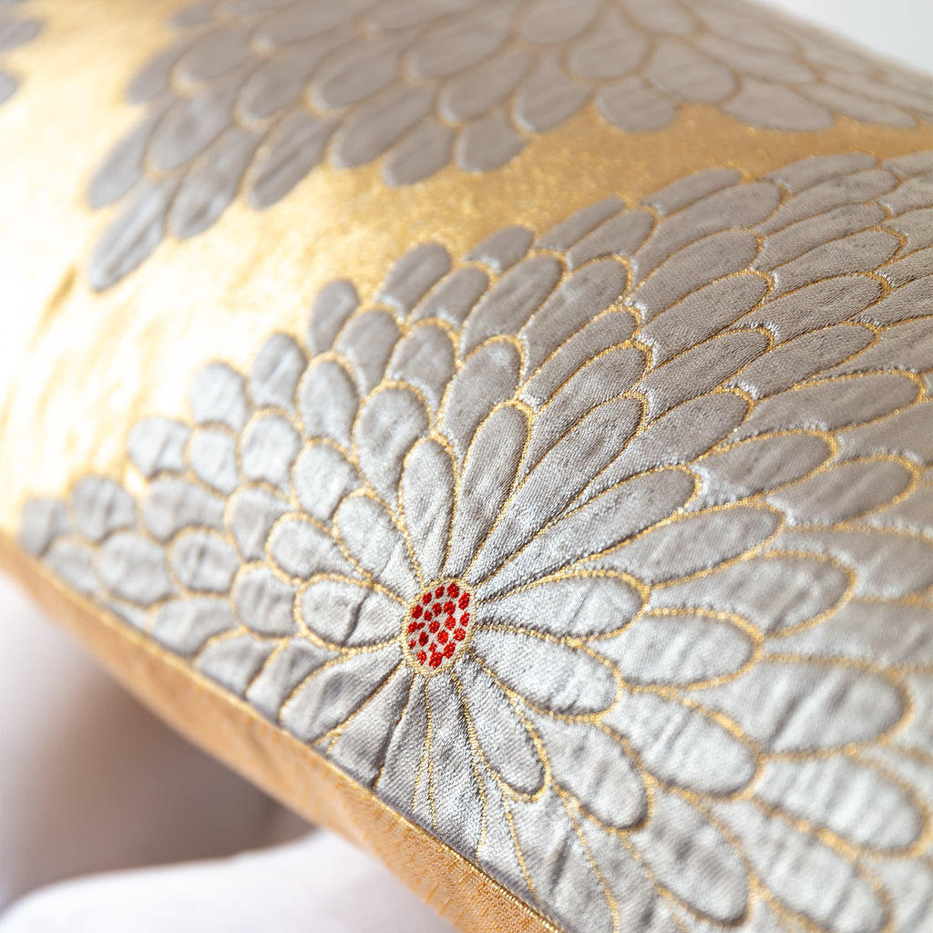 Raised silver chrysanthemum weave detail with red accent on gold obi bolster
