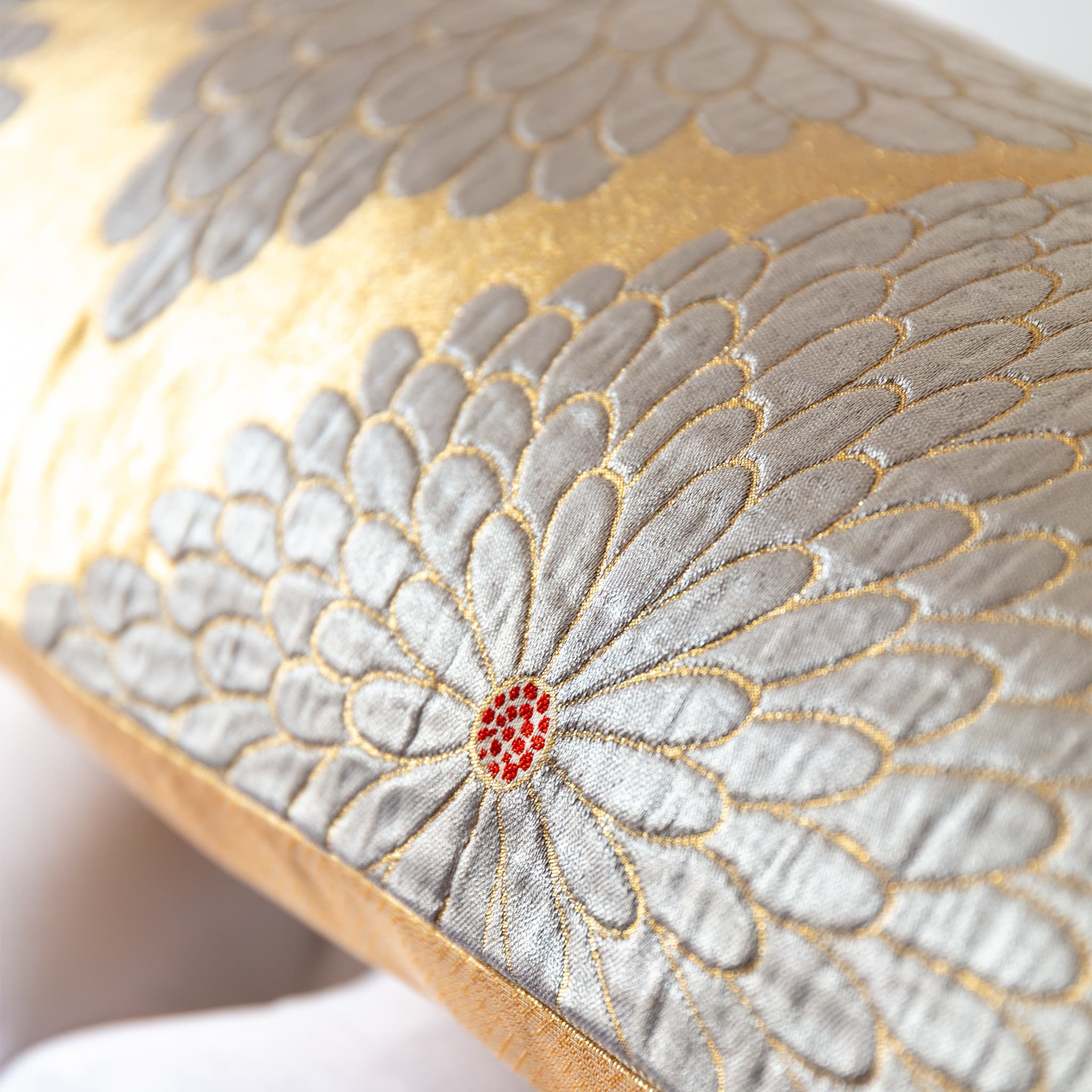 Raised silver chrysanthemum weave detail with red accent on gold obi bolster