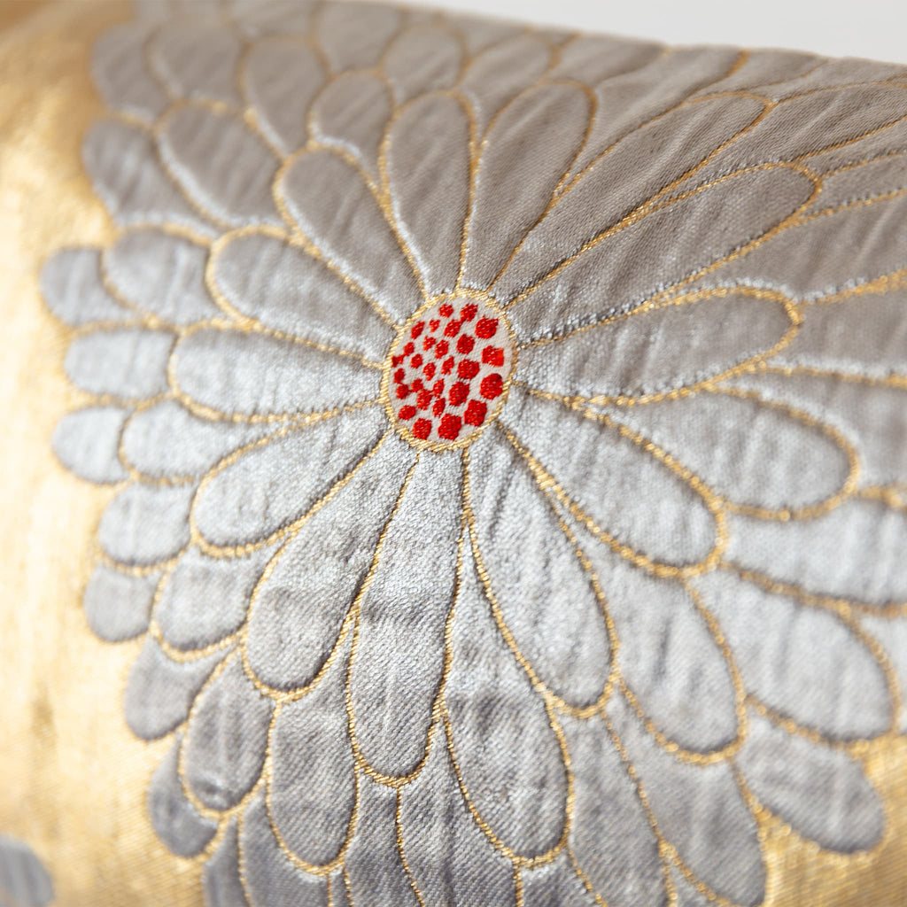 Silver chrysanthemum motif detail on gold silk vintage Japanese obi bolster cushion