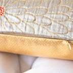 Close-up of a kimono cushion with gold and silver floral patterns showing concealed zip at base.