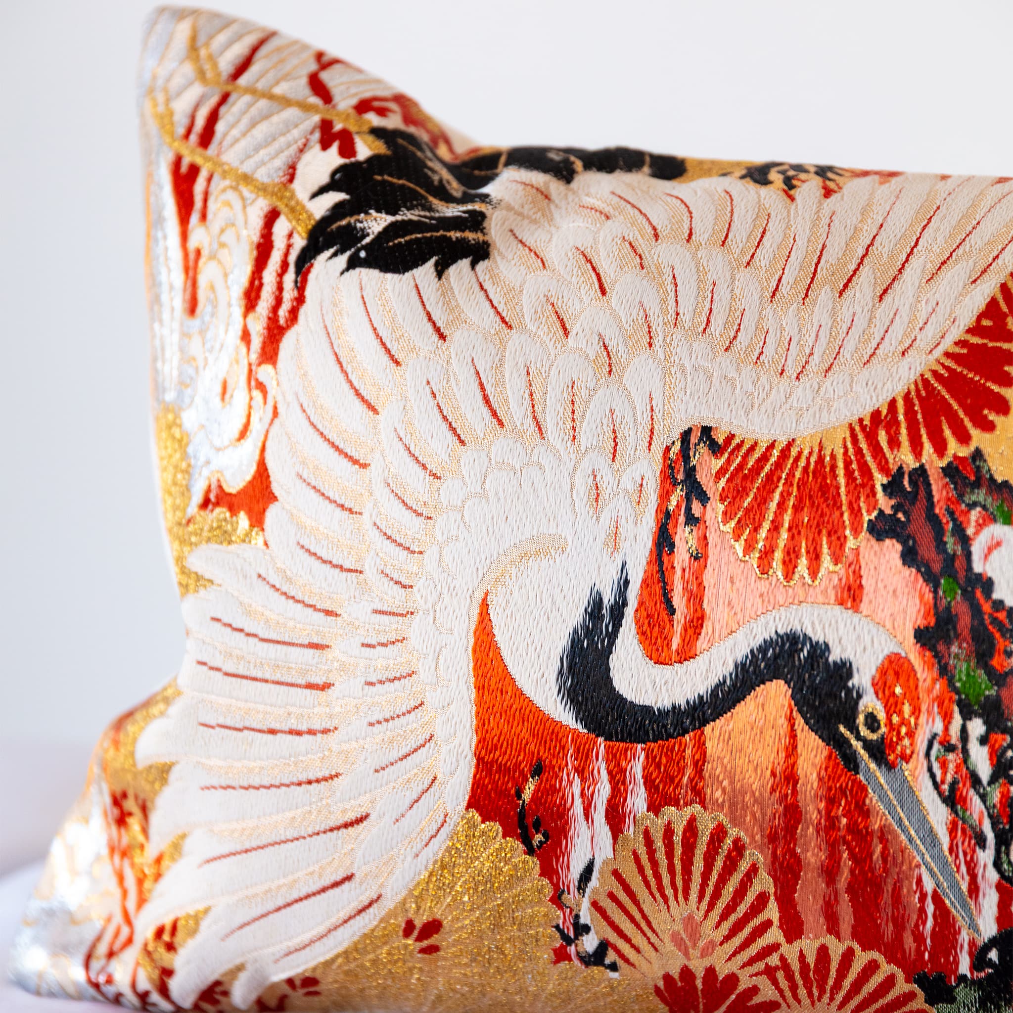 Soaring white crane and plum blossom detail, vintage Japanese Maru Obi silk bolster cushion corner