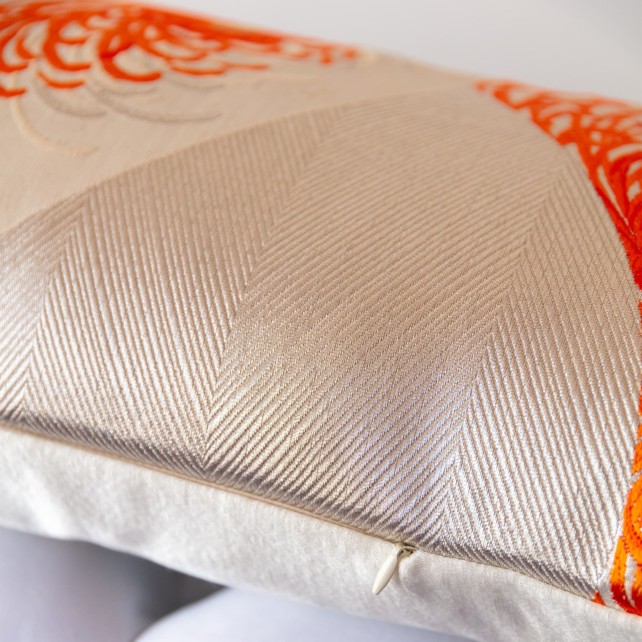 Long silk bolster cushion close up of concealed zip at base.