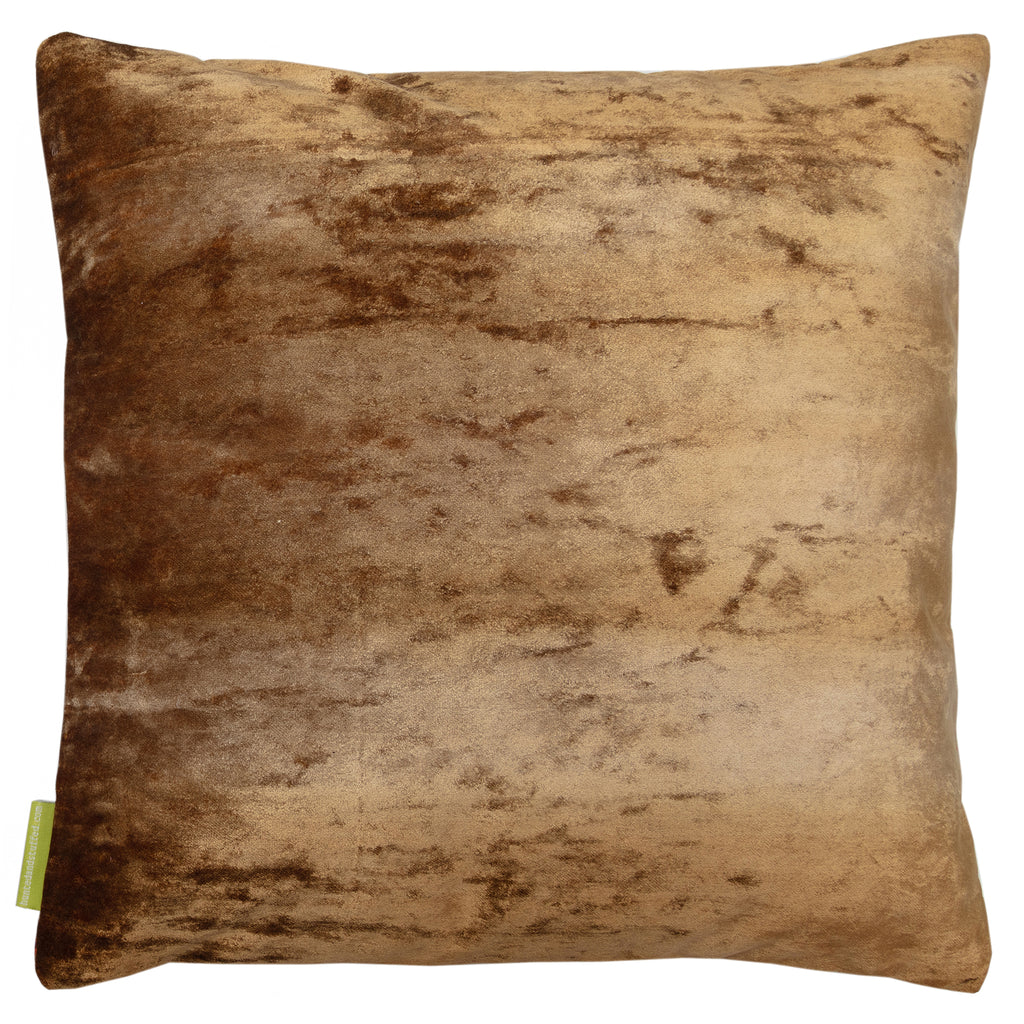 Close-up of vibrant green silk fabric with subtle gold velvet floral embroidery on the cushion's corner detail