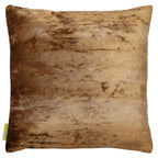 Close-up of vibrant green silk fabric with subtle gold velvet floral embroidery on the cushion's corner detail