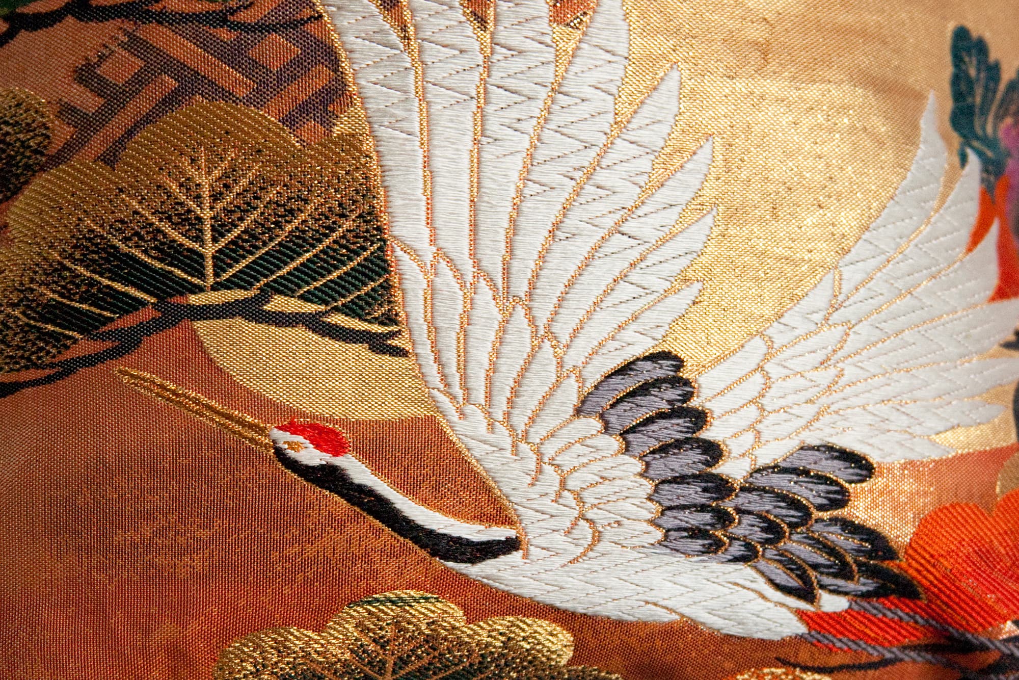 Crane motif on Japanese silk textile with gold woven background (Tsuru)