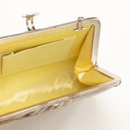 Interior of vintage Japanese silk clutch  bag, cream silk lining, interior pocket and view of silver metal frame and clasp open