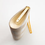 Side view of vintage Japanese silk clutch  bag in gold, showing pattern on gold frame and gold chain strap