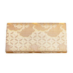 Reverse view of a gold silk vintage Japanese clutch  bag with geometric design on a white background.