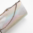 Close up of vintage Japanese clutch bag in iridescent silver silk with river pattern. The bag is closed and the decorative silver chain strap drapes over the front of the bag.