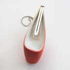 Side view of a vintage Japanese silk clutch bag with silver side panel in silk and the silver bag frame closed.